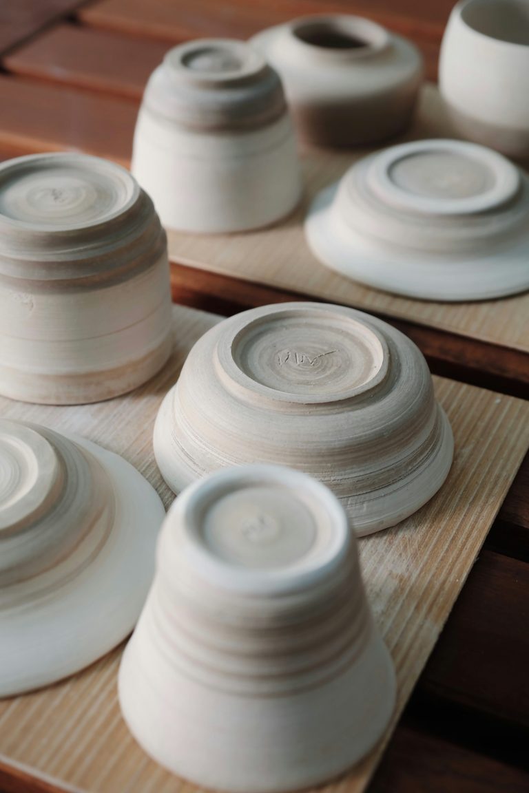 Handmade Japanese ceramic bowls drying on a wooden shelf