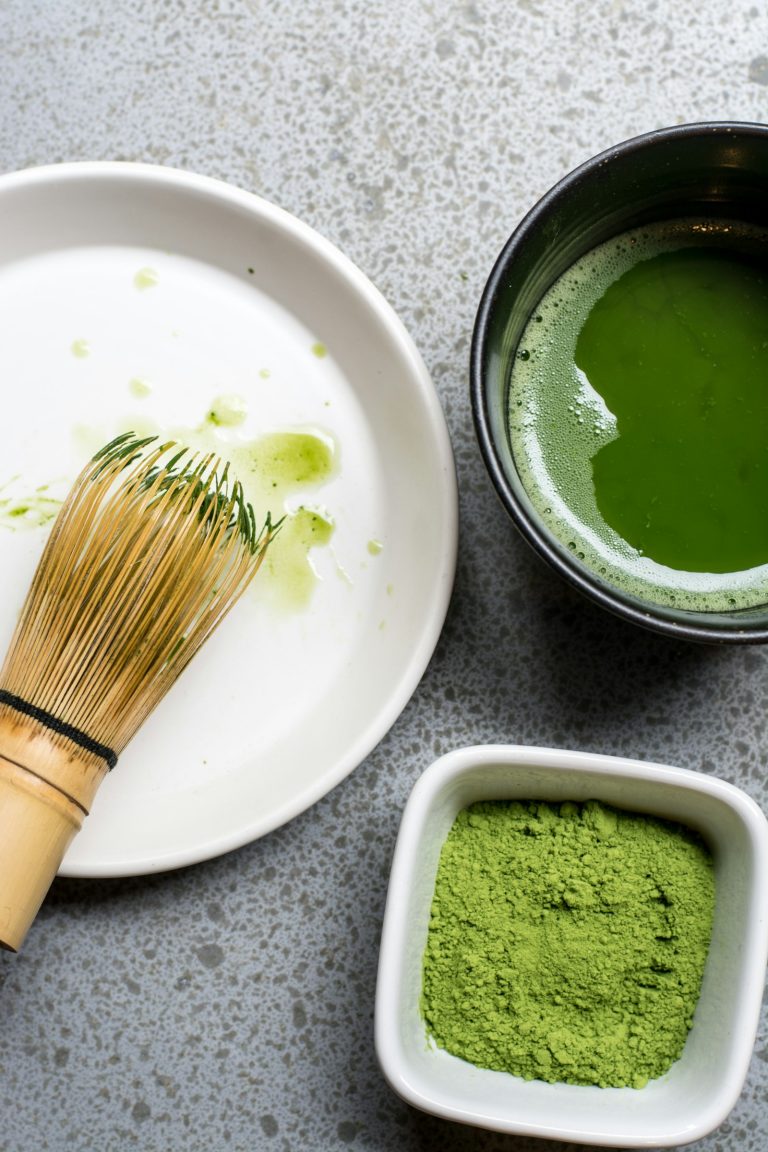 A matcha set: bamboo whisk, prepared matcha and matcha powder