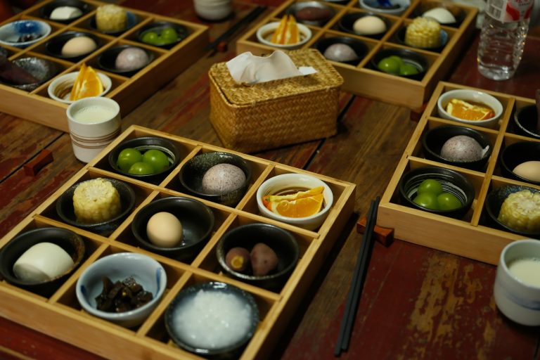 Assorted Japanese small dishes arranged on a wooden tray