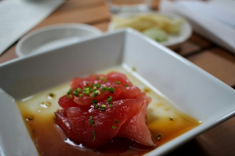 Japanese sushi served on a square white ceramic plate