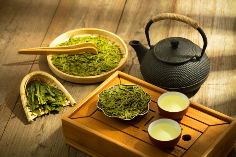 A Japanese teapot with two cups of green tea